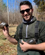 Dr. Michael Graziano outside holding 3 turtles