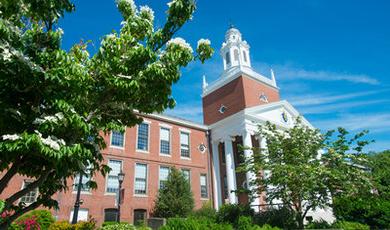 Boyden Hall surrounded by green grass and flowering trees